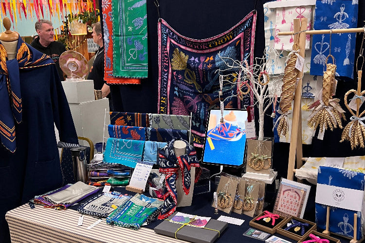 Christmas market stall with straw and scarves