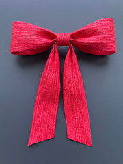 Large decorative red bow made with straw braid